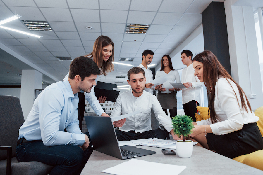 Making business plan. Group of young freelancers in the office have conversation and smiling